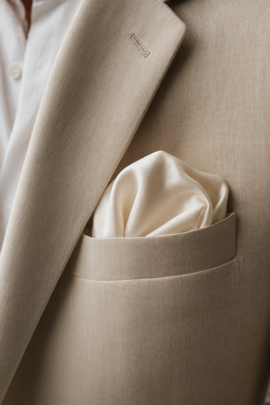 The pocket-square fold — a silk square styled as described